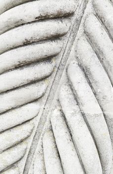 Column decorated stone detail of a textured stone background, ancient architecture