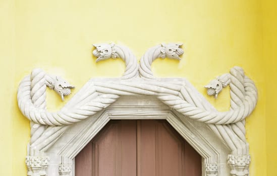 Old door decorated in Sintra, detail of decoration in a castle in Portugal, Manueline arches decorated