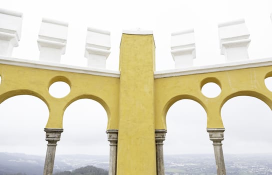 Ancient yellow arches in the Pena Palace, detail of ancient architecture, heritage of humanity, tourism