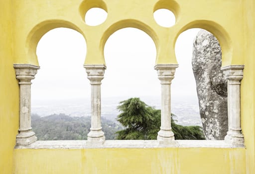 Ancient yellow arches in the Pena Palace, detail of ancient architecture, heritage of humanity, tourism
