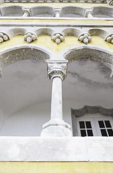 Ancient yellow arches in the Pena Palace, detail of ancient architecture, heritage of humanity, tourism