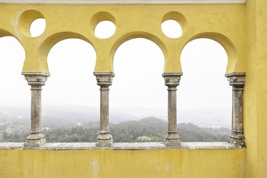 Ancient yellow arches in the Pena Palace, detail of ancient architecture, heritage of humanity, tourism
