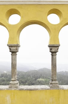 Ancient yellow arches in the Pena Palace, detail of ancient architecture, heritage of humanity, tourism