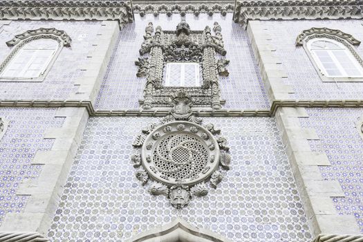 Old facade with typical tiles from Lisbon, detail of a decorated wall, typical architecture of Portugal