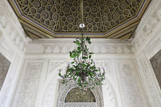 Old lamp chandelier, detail of a bronze lamp inside a castle, ancient art