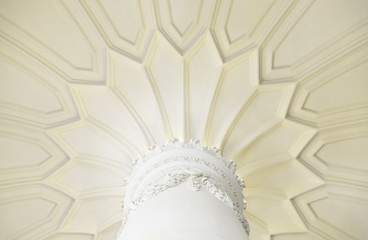 Ancient column in interior detail of a decorated column, white marble