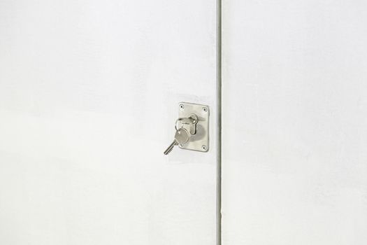 Key in a lock door, detail of a metal key in a lock, protection and security