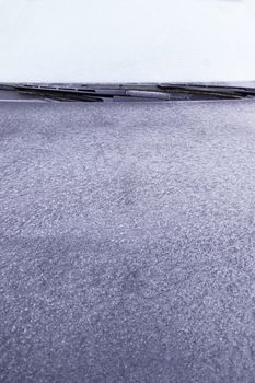 Blue ice on a wall, detail of a frozen wall, cold winter in the city