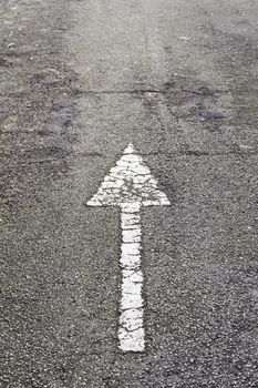 Arrow direction on asphalt, detail of an arrow of indexation on a highway, road information