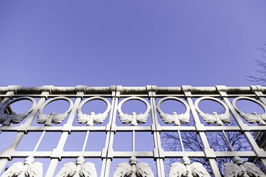 White metal railing, detail of a guardrail and decoration, exterior and sky