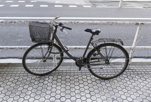 Bicycle parked in the city, detail of a publishing vehicle for city traffic, sport and environment