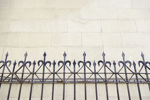 Metal railing on a church, detail of a metal shield on a facade, art and Safety