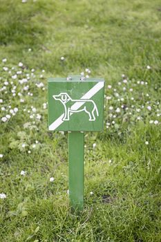 Signal not dogs on grass, detail of a prohibition sign on a lawn, information