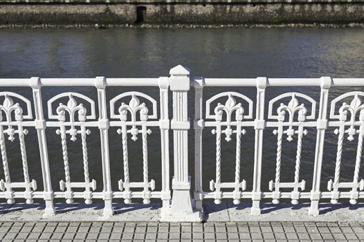 White metal railing, detail of a guardrail and decoration in the city