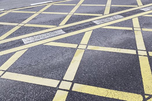 Yellow traffic sign on asphalt, detail of a sign on a road in city