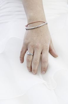 Hand of bride with wedding ring, detail of a woman on her wedding day, married alliance