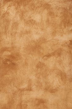 Grunge beige brown faded uneven old aged daub plaster wall texture background with stains and paint strokes, close up, vertical