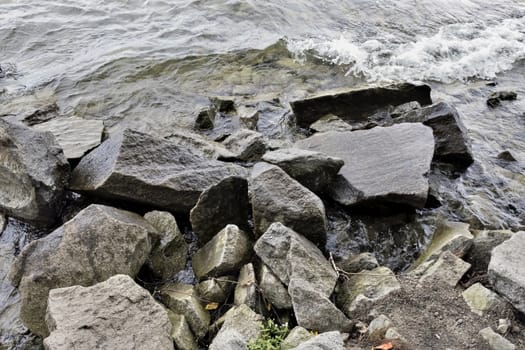 large stones on the lake shore in windy weather