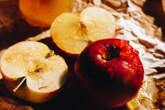 Honey with wooden honey dipper and fruits on wooden table close up