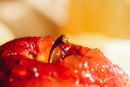 Honey with wooden honey dipper and fruits on wooden table close up