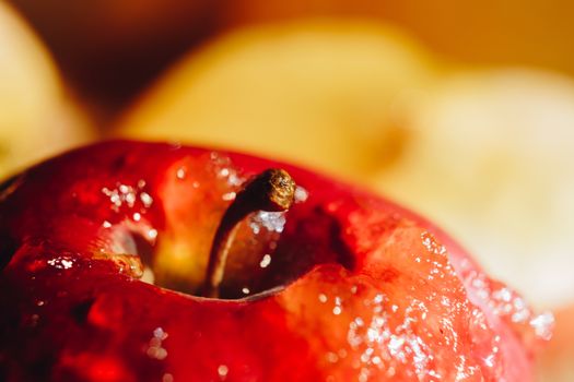 Honey with wooden honey dipper and fruits on wooden table close up