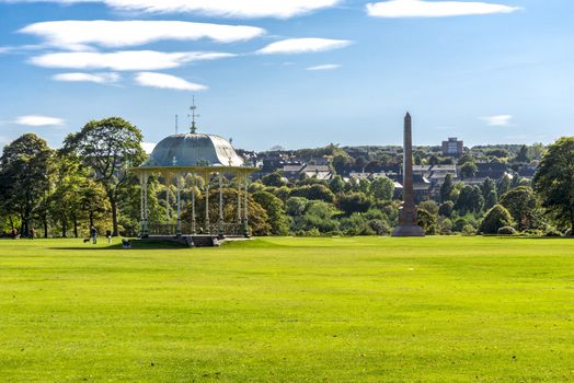 A large lawn with a scenic arbour and McGrigor obelisk in Duthie Park, Aberdeen, Scotland