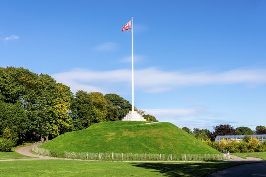 The Mound (artificial hill) wiith a tall flagpole in Duthie Park, Aberdeen, Scotland