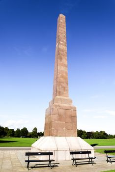 Benches in front of a scenic McGrigor obelisk in Duthie Park, Aberdeen, Scotland