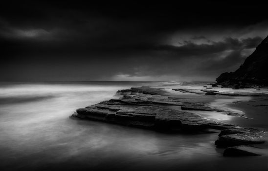 Storm clouds moving out o sea in he dawn hours. Long exposure