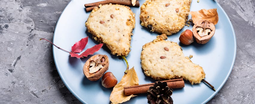 Cookies with nuts and cinnamon, in the form of a pear. Autumn baking