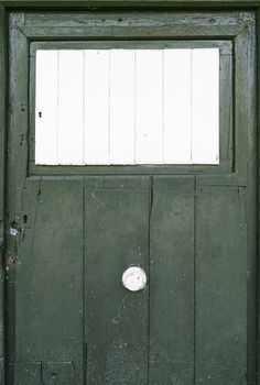 Green wooden door, white, detail of an old country door, antique wooden