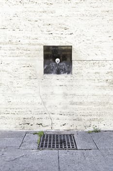 Source on the wall, detail of a modern fountain in the city, drinking water