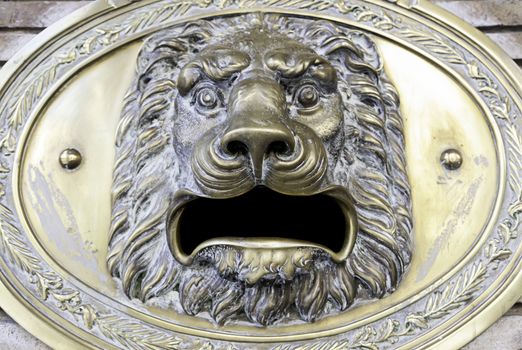 Lion head fountain, detail of a lion-shaped fountain, street art