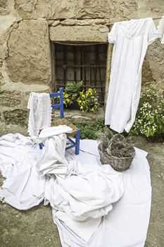 Old rural scene, detail of an old scene in a village in Spain, chair and linen