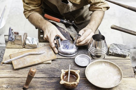 Worker metal craftsman, an artisan detail, tradition and old work