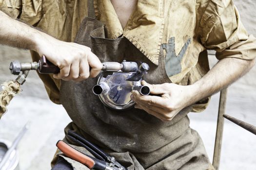 Worker metal craftsman, an artisan detail, tradition and old work