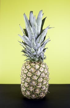 Pineapple on yellow background, detail tropical fruit on colorful background, fresh food diet