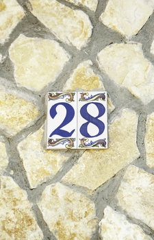 Number twenty-eighth in a stone wall, detail information about numbers on the street