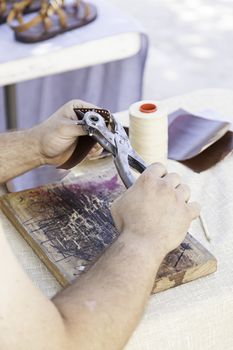 Man working with leather, detail of a person working with your hands