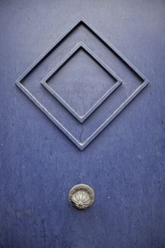 Old blue door, detail of a door in the city, urban decoration, exterior