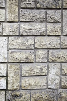 Synthetic stone wall, detail of a modern facade in the city