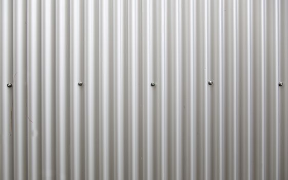 Corrugated metal wall, detail of a wall lined with metal, shiny steel
