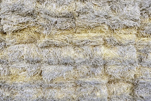 Hay Mountain, detail of a bale of straw on a farm, grain textured background