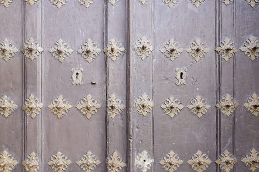 Old decorated wooden door, detail of a door in a house, protection and security, wood decor