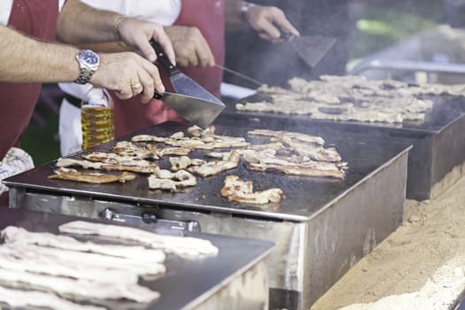 Roasting bacon in grilled pork detail on a griddle to cook, roast