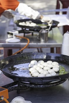 Cooking mushrooms on the street, detail of a person making grilled mushrooms, healthy food, celebration