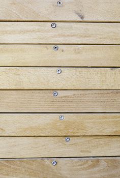 Wooden background with texture, detail of a wooden wall with screws background texture
