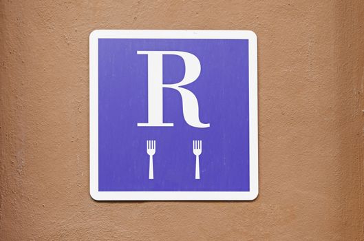 Plate with restaurant sign, detail of an information signal of a place for lunch or dinner