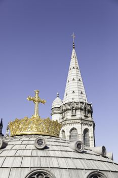 Tower and cross Lourdes Church, detail of an old building and religious classic