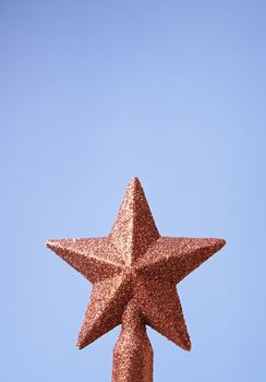 Christmas star on the tree, detail of Christmas decoration, celebration and happiness